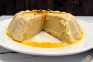 kesar pista kulfi with saffron milk and pistachio on top
