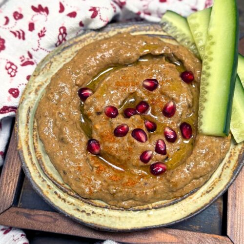 lebanese baba ganoush with pomegranate arils and cucumber slices on the side