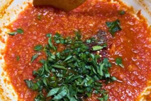 oregano and basil added to the sauce