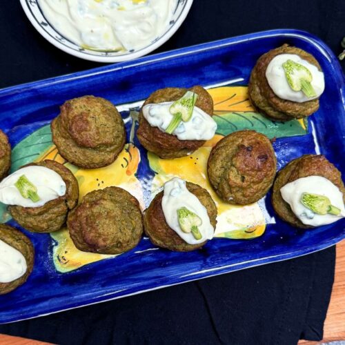 purslane recipe with yogurt dip and garlic buds on a blue platter