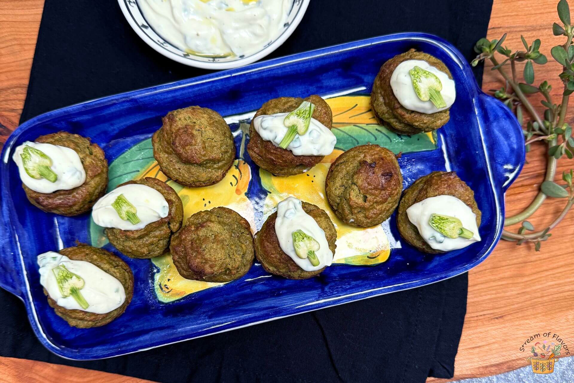 purslane recipe with yogurt dip and garlic buds on a blue platter
