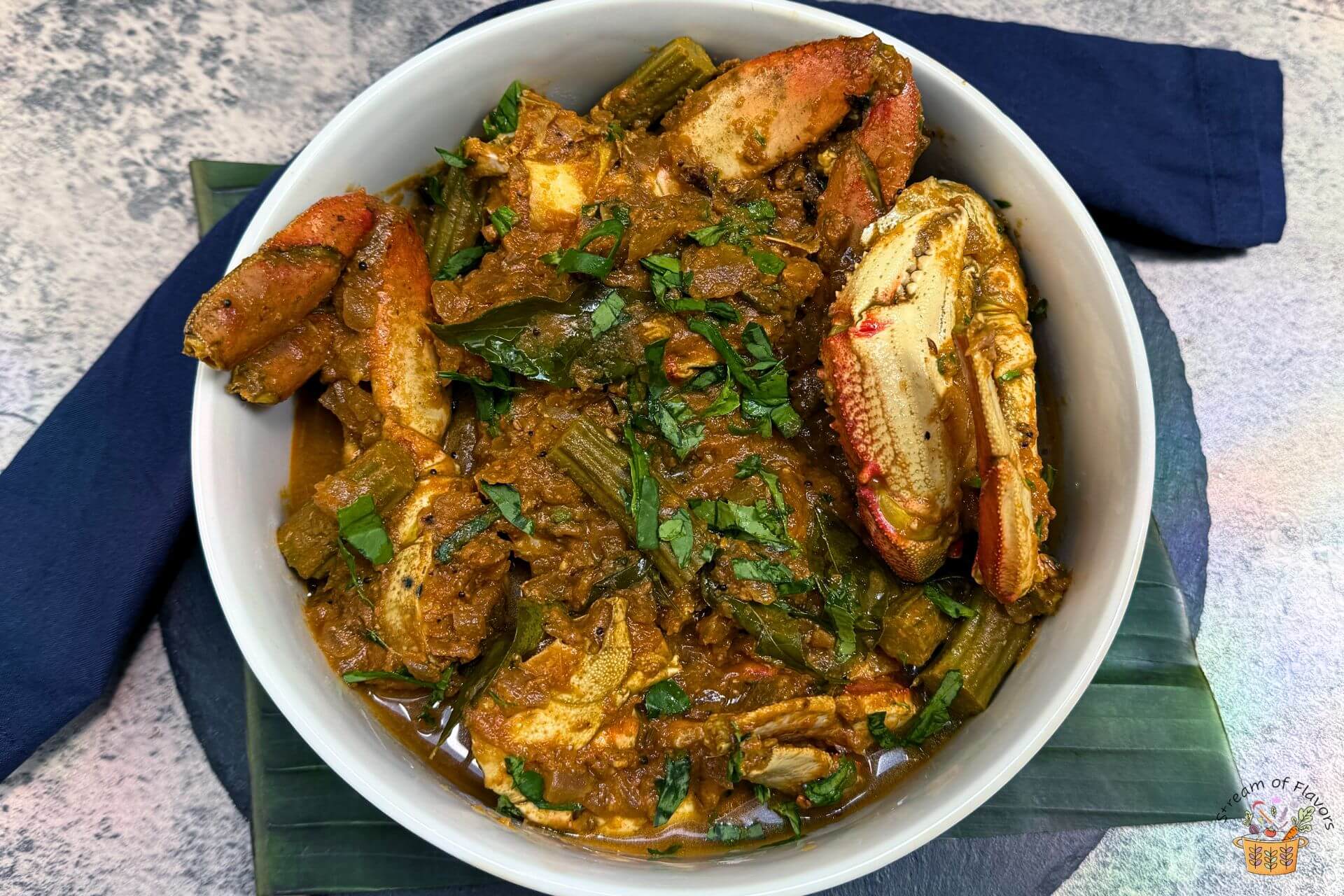 crab curry recipe in a bowl with fenugreek leaves