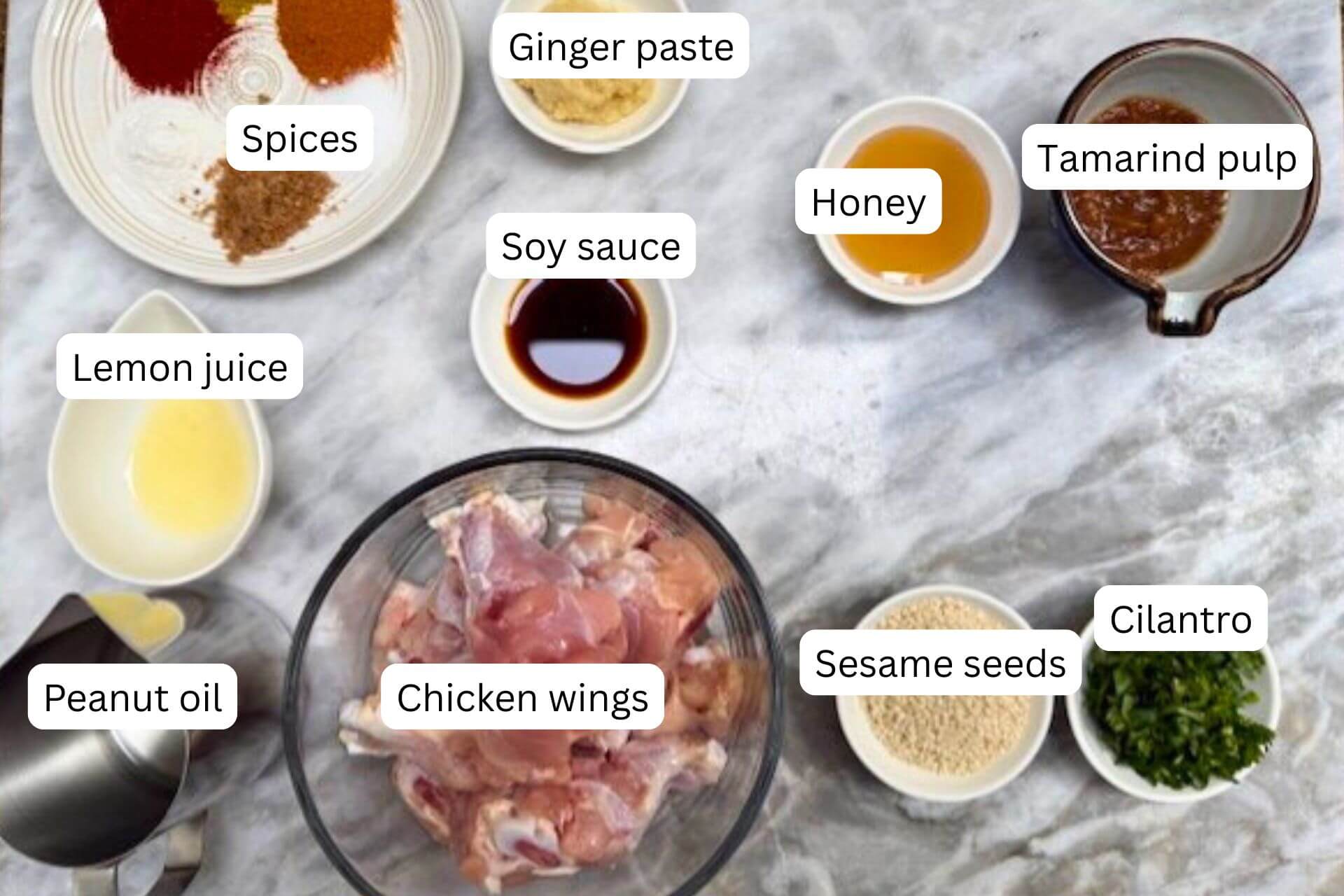 measured ingredients in bowls for the chicken wings