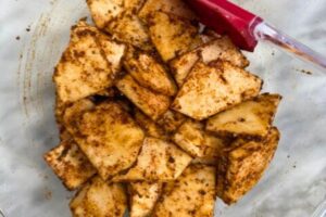 spices rubbed onto the celery root slices