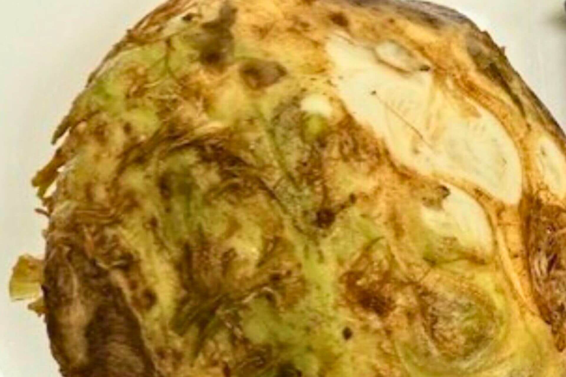 celery root skin being removed with a knife