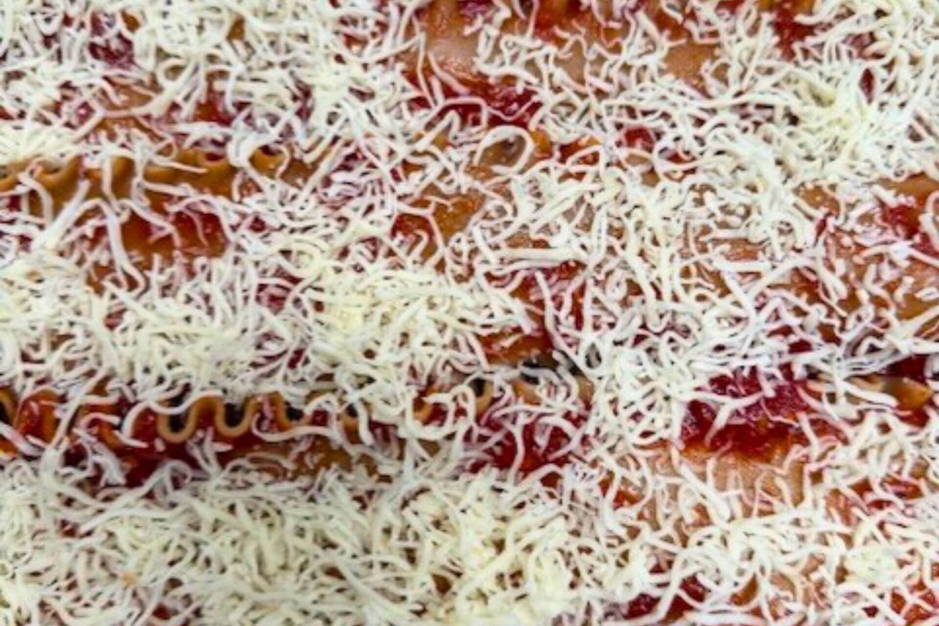 shredded mozzarella on the lasagna