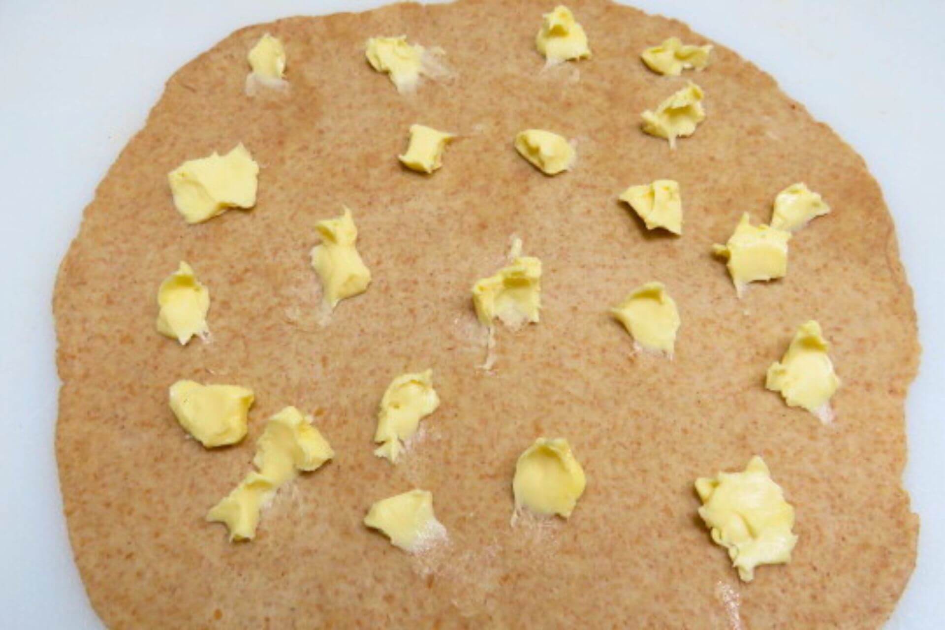 pieces of butter placed on the rolled discs