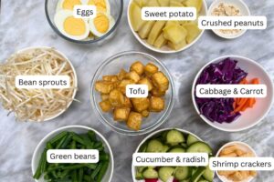 measured ingredients in bowls for the salad with vegetables, tofu and boiled eggs