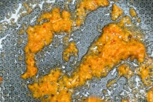 saute the spice paste in a wok