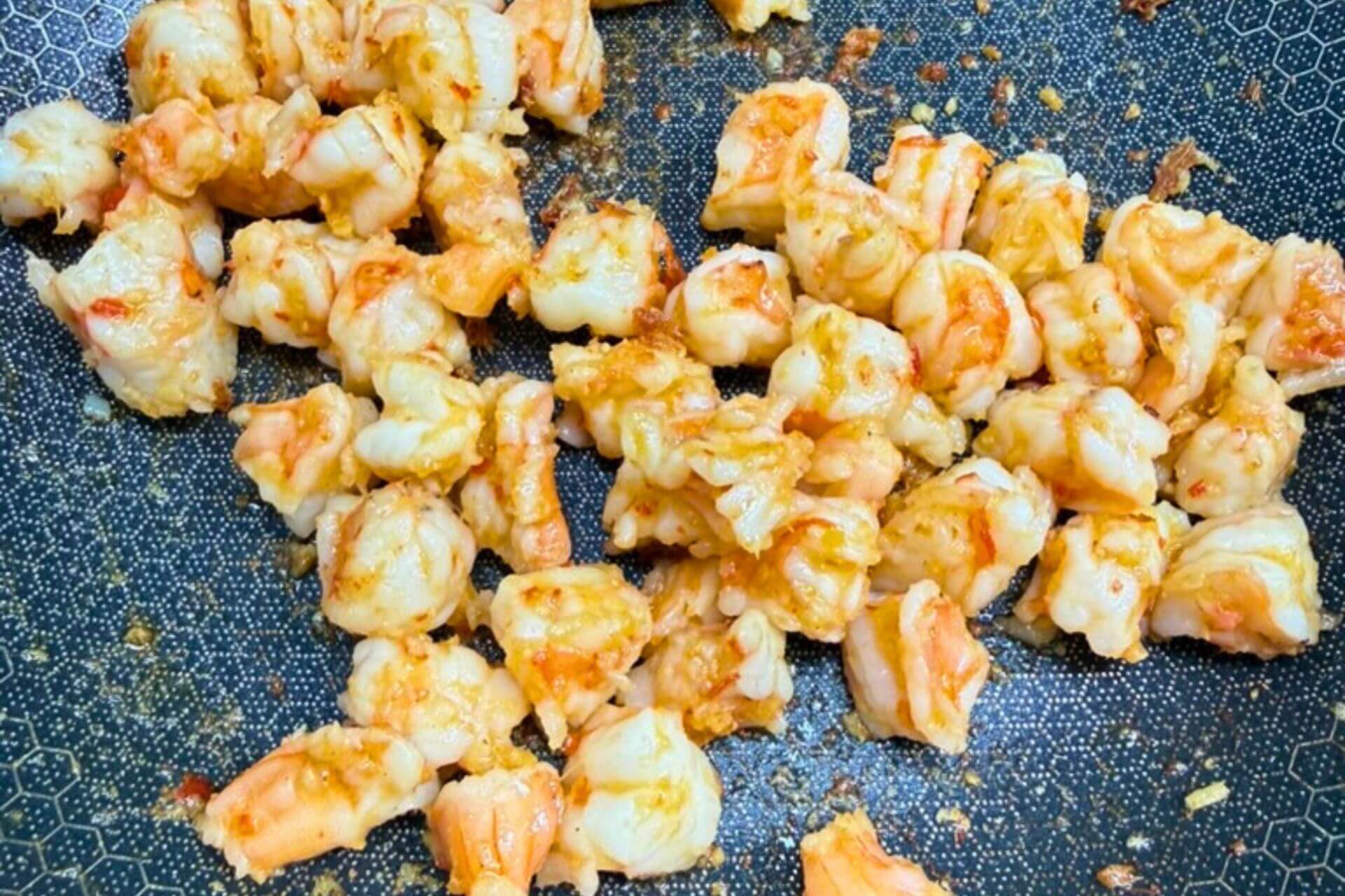 shrimp fried with the spice paste in a wok