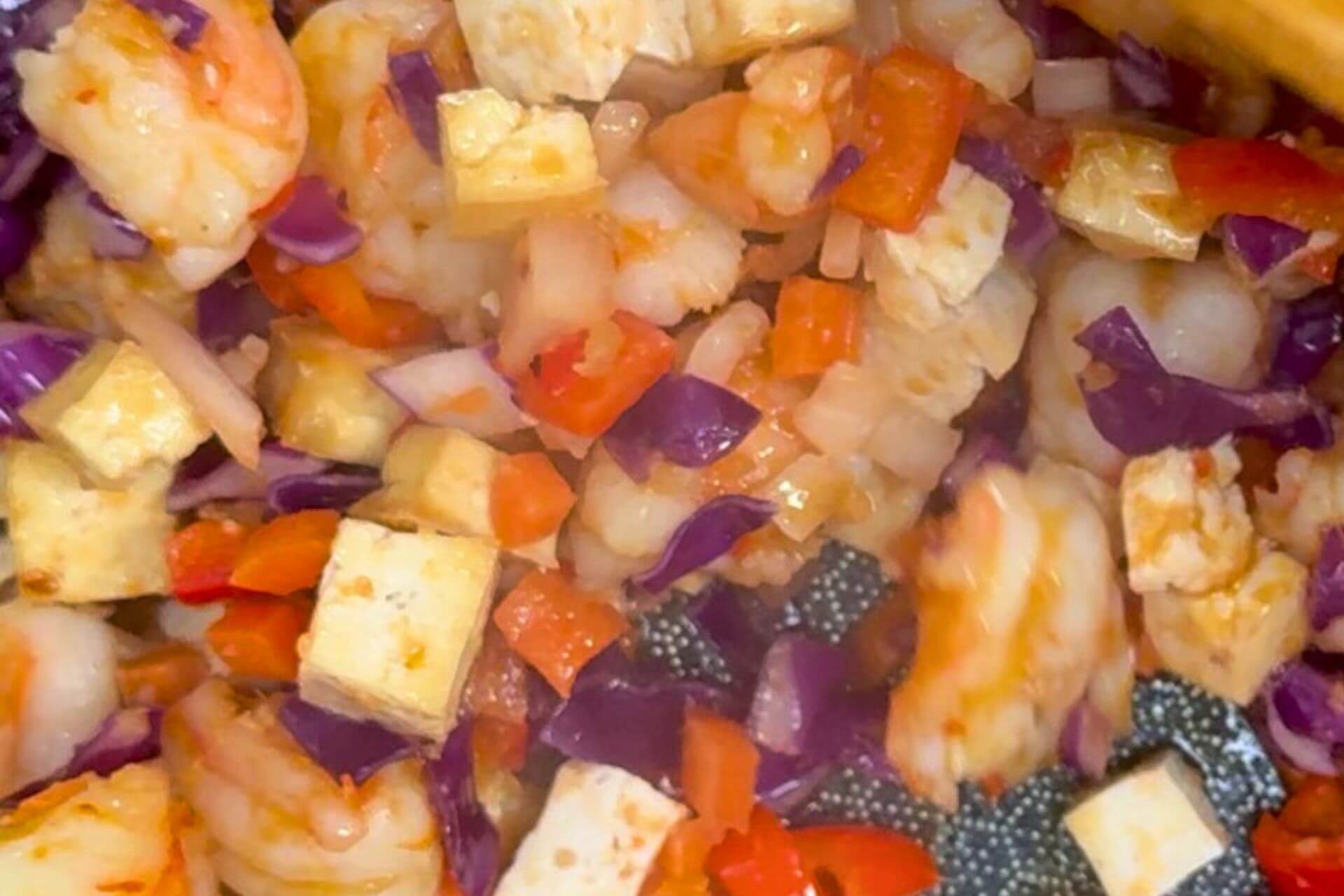 tofu, red cabbage, carrots , shallot and sauces added to the mixture