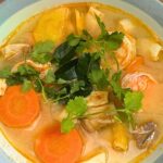 Tom yum goong recipe in a bowl with cilantro