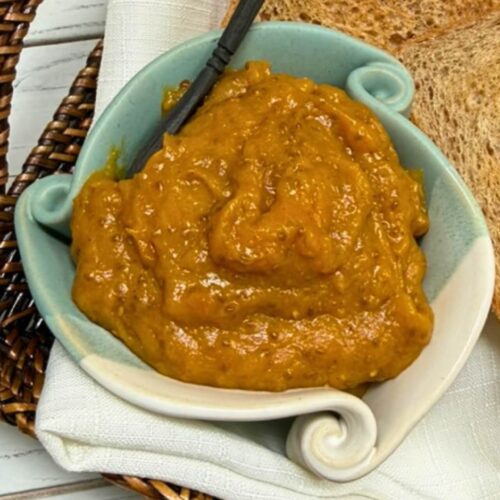 sugar free mango jam in a light blue bowl with a slice of bread