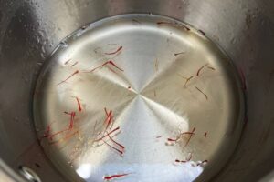 simmer the sugar syrup in a pot with saffron