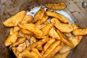 apple slices cooked with date sugar in a pot