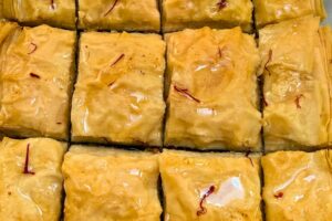 cooled syrup poured over hot baklawa