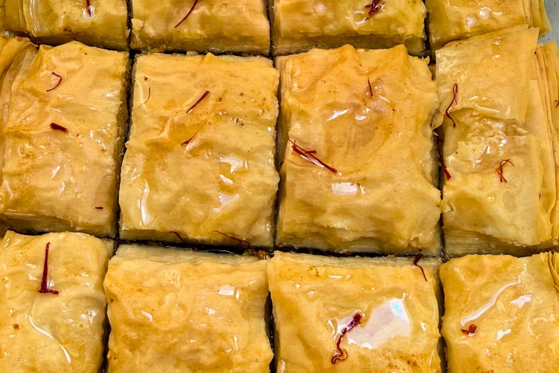 cooled syrup poured over hot baklawa