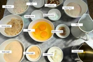 measured ingredients in bowls for the oat flour muffins