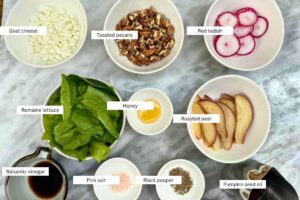 measured ingredients in bowls for the pear and lettuce salad